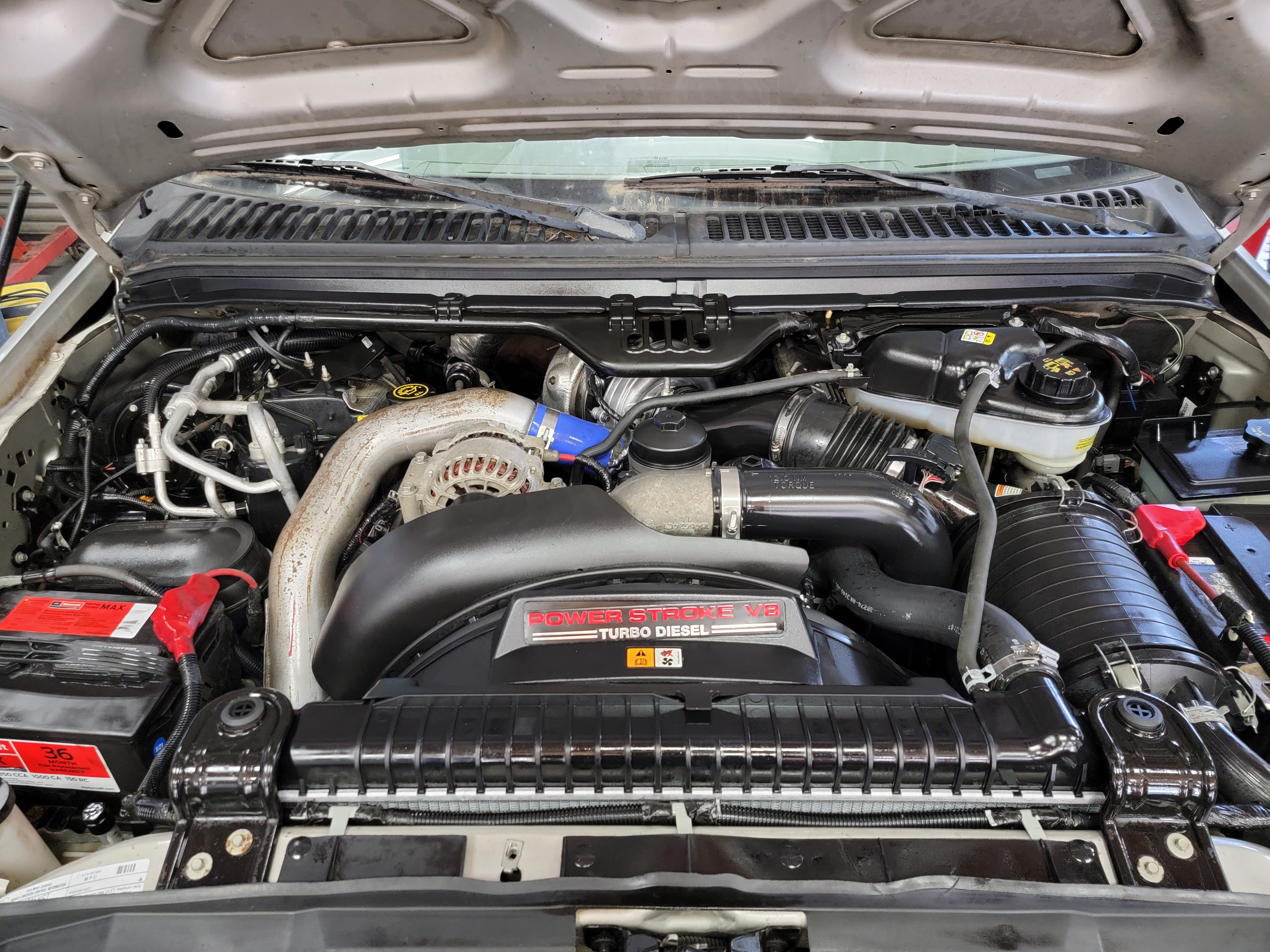 A 6.0L Power Stroke engine bay during a bulletproofing build at CSC Diesel